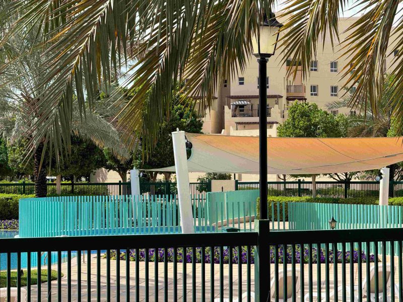 Swimming pool in the community with poolside lounge chairs