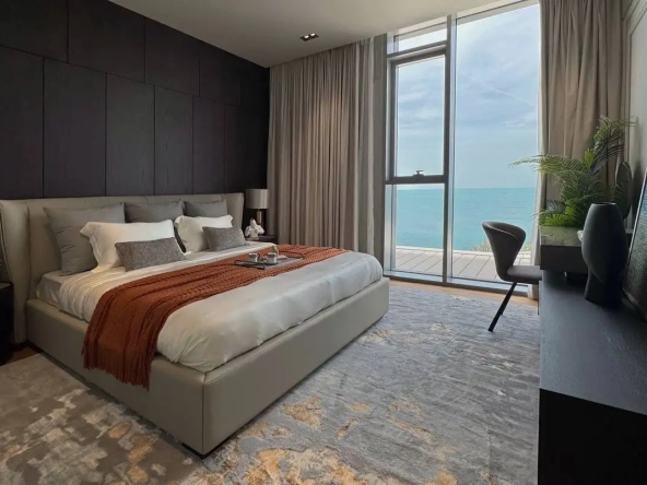 En-suite master bedroom with walk-in closet and balcony overlooking the sea